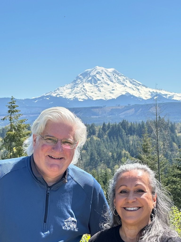 David Sturm and Emily Peña Howell near Bonney Lake, with Mount Rainier behind them