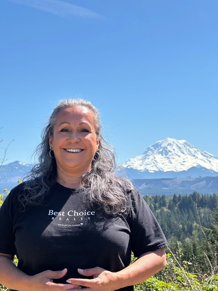 Emily Peña Howell, Best Choice Realty, with Mount Rainier behind her